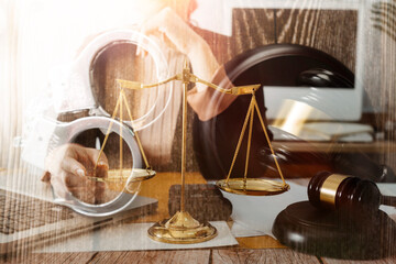 justice and law concept.Male judge in a courtroom on wooden table and Counselor or Male lawyer working in office. Legal law, advice and justice concept.