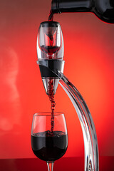 Fototapeta na wymiar pour wine through the aerator to oxygenate the wine, stream the wine with bubbles
