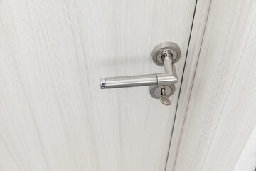 wooden room door with metal handle