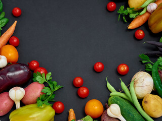 Frame of various  vegetables on dark background, top view.