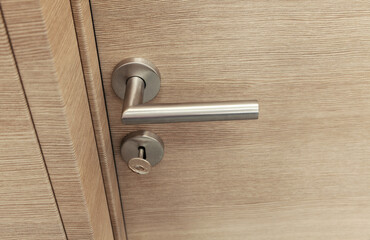 wooden room door with metal handle