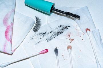 cosmetic scene with makeup smears and q tips on a tissue