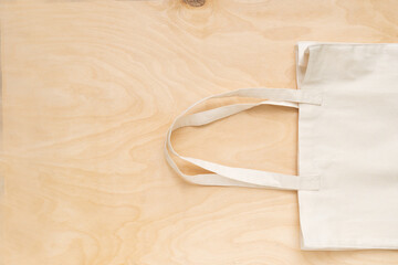Reusable shopping bag on wooden background. Cotton shopper on gray background,place for text
