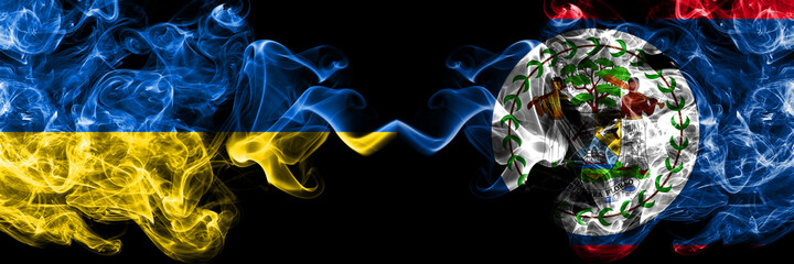 Ukraine, Ukrainian vs Belize, Belizean smoky mystic flags placed side by side. Thick colored silky abstract smokes flags.