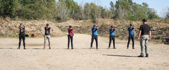 Group of students on training for handling and shooting in shooting range