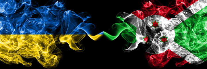 Ukraine, Ukrainian vs Burundi, Burundian smoky mystic flags placed side by side. Thick colored silky abstract smokes flags.