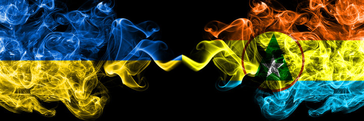 Ukraine, Ukrainian vs Cabinda smoky mystic flags placed side by side. Thick colored silky abstract smokes flags.