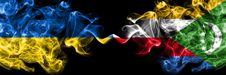 Ukraine, Ukrainian vs Comoros, Comorian smoky mystic flags placed side by side. Thick colored silky abstract smokes flags.