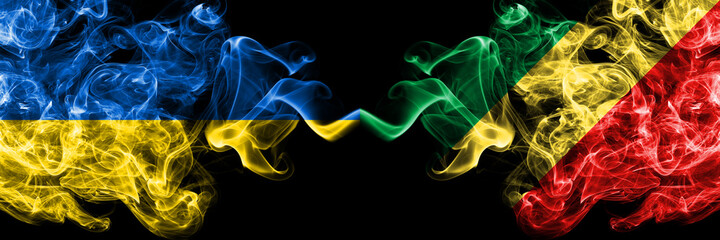 Ukraine, Ukrainian vs Congo, Congolese smoky mystic flags placed side by side. Thick colored silky abstract smokes flags.