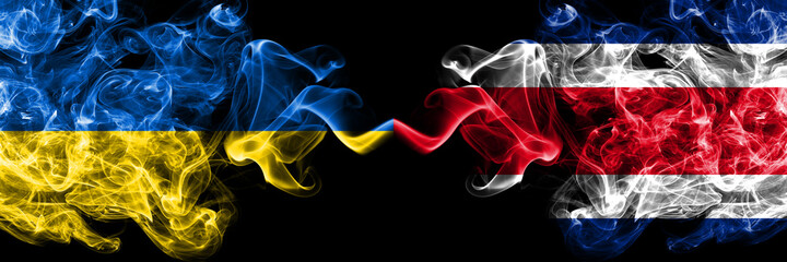 Ukraine, Ukrainian vs Costa Rica smoky mystic flags placed side by side. Thick colored silky abstract smokes flags.