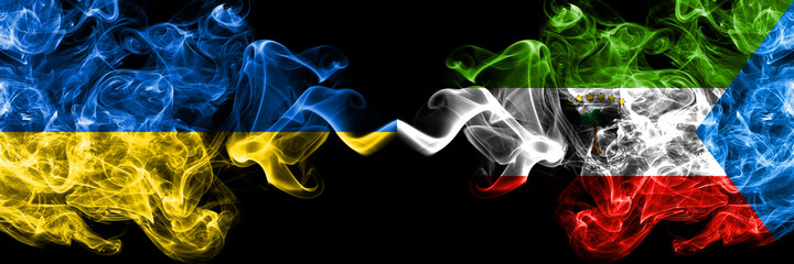 Ukraine, Ukrainian vs Equatorial Guinea smoky mystic flags placed side by side. Thick colored silky abstract smokes flags.