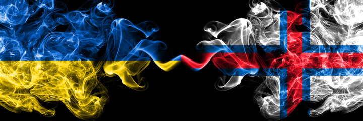 Ukraine, Ukrainian vs Faroe Islands, Faroese smoky mystic flags placed side by side. Thick colored silky abstract smokes flags.