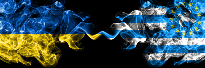 Ukraine, Ukrainian vs Federal Republic of Southern Cameroons smoky mystic flags placed side by side. Thick colored silky abstract smokes flags.