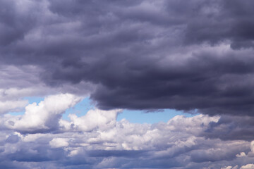 Naklejka na ściany i meble Epic dramatic Storm sky, dark grey and white cumulus clouds on blue sky background texture, thunderstorm