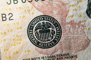 macro photo of federal reserve system symbol on hundred dollar bill. shallow focus. close-up with fine and sharp texture