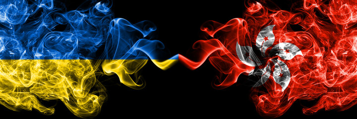 Ukraine, Ukrainian vs Hong Kong, China, Chinese smoky mystic flags placed side by side. Thick colored silky abstract smokes flags.