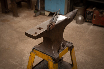 Tools for forging in a blacksmith shop.
The pliers lie on the anvil.