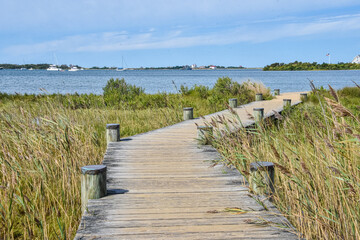 A boardwalk leads to the shore of Great Salt Pond.  Block Island, Rhode Island.  Copy space.