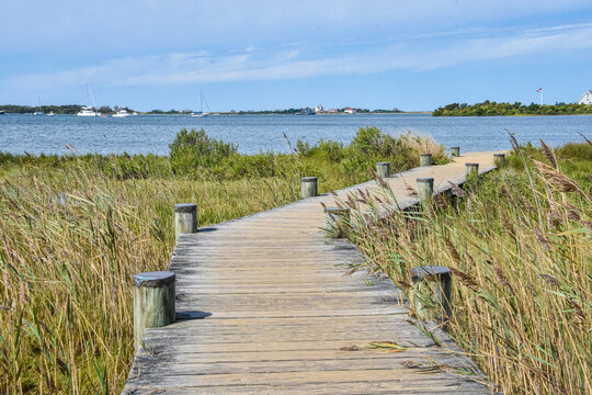 A boardwalk leads to the shore of Great Salt Pond.  Block Island, Rhode Island.  Copy space.