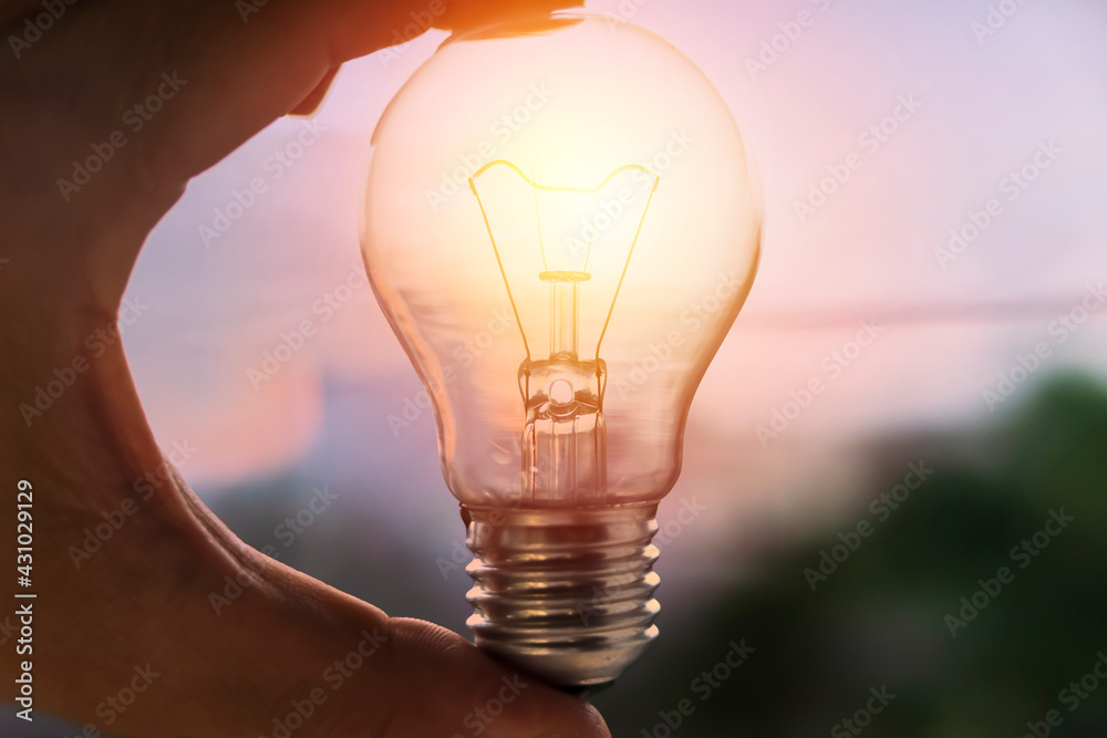 Wall mural hand holding light bulb. idea concept with innovation and inspiration for good idea