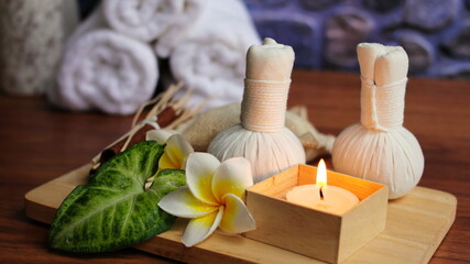 Spa candles with towels,Spa accessories,Beautiful composition of spa , spa relax concept,  herbs for massage, beautiful sap set on wood table,For marketing products