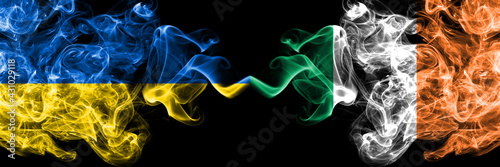 Ukraine, Ukrainian vs Ireland, Irish smoky mystic flags placed side by side. Thick colored silky abstract smokes flags.