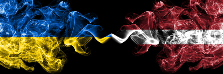 Ukraine, Ukrainian vs Latvia, Latvvian smoky mystic flags placed side by side. Thick colored silky abstract smokes flags.