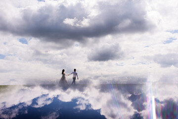 View from distance.newlyweds walk in the clouds. Fabulous honeymoon. Concept of honeymoon
