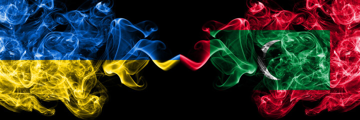 Ukraine, Ukrainian vs Maldives, Maldivian smoky mystic flags placed side by side. Thick colored silky abstract smokes flags.