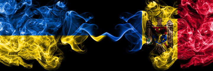 Ukraine, Ukrainian vs Moldova, Moldovan smoky mystic flags placed side by side. Thick colored silky abstract smokes flags.