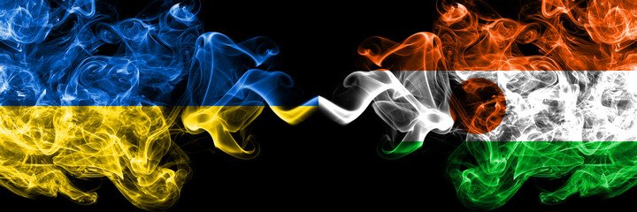 Ukraine, Ukrainian vs Niger, Nigerien smoky mystic flags placed side by side. Thick colored silky abstract smokes flags.