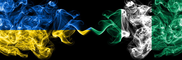 Ukraine, Ukrainian vs Nigeria, Nigerian smoky mystic flags placed side by side. Thick colored silky abstract smokes flags.