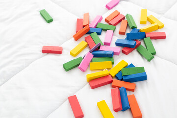 Colored wooden toy on a white background. Toy blocks, multicolor wooden bricks on white background.