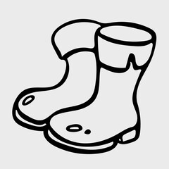 Boots icon in doodle style. Autumn shoes simple sketch.