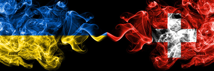 Ukraine, Ukrainian vs Switzerland, Swiss smoky mystic flags placed side by side. Thick colored silky abstract smokes flags.