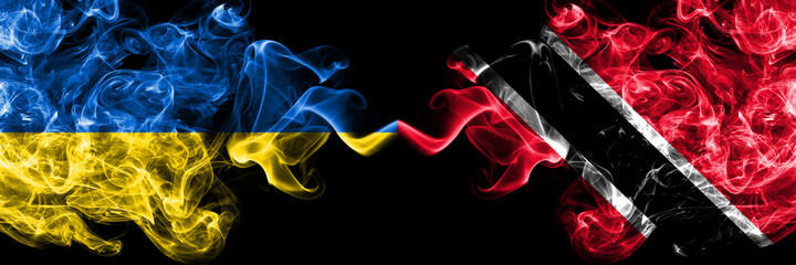 Ukraine, Ukrainian vs Trinidad and Tobago smoky mystic flags placed side by side. Thick colored silky abstract smokes flags.