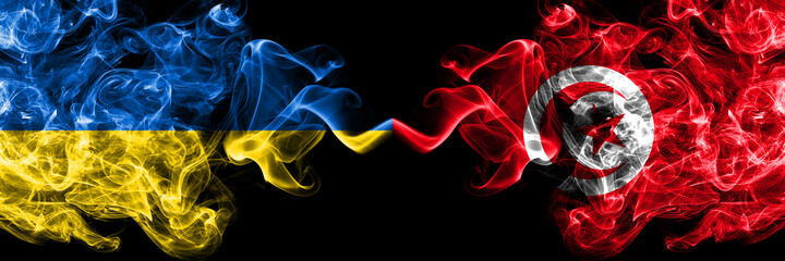 Ukraine, Ukrainian vs Tunisia smoky mystic flags placed side by side. Thick colored silky abstract smokes flags.