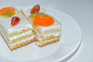 White fruit delicious cake on a white plate