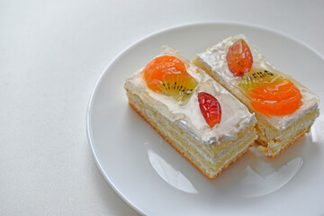 White fruit delicious cake on a white plate
