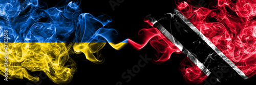 Ukraine, Ukrainian vs Trinidad and Tobago smoky mystic flags placed side by side. Thick colored silky abstract smokes flags.