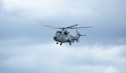 Helicóptero militar fazendo treinamento de resgate.