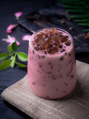 Rose milk tea with bubble (tapioca ball)on wood background