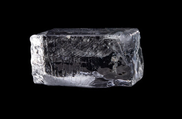 Large melting cube of clear ice on black background,Translucent ice block