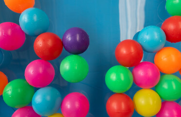 Fototapeta na wymiar Colorful inflatable balls in blue Inflatable pool.