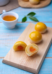 Chinese pastry puff, Beans cake with salted egg yolk lay on table wood,Homemade bakery concept.