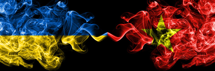 Ukraine, Ukrainian vs Vietnam smoky mystic flags placed side by side. Thick colored silky abstract smokes flags.
