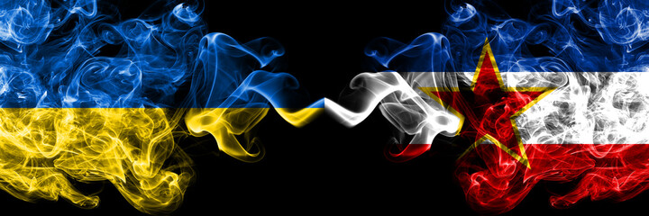Ukraine, Ukrainian vs Yugoslavia, Yugoslavian smoky mystic flags placed side by side. Thick colored silky abstract smokes flags.