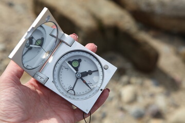 Geological compass on woman's hand. Topography and geodesy measurements. Laboratory for the...