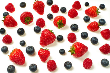 Blueberries, strawberries and raspberries on a white background.