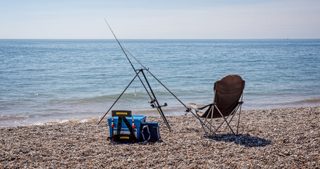 Fototapeta na wymiar Pair of fishing rods set up on beach for sea fishing